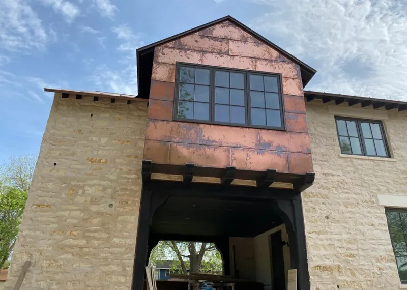 Copper metal panel facade on a stone building for Roof Repair in Loma Linda
